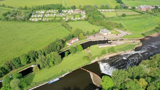 Aerial view of the caravan park with surrounding fields and trees at York Naburn Lock Caravan Park